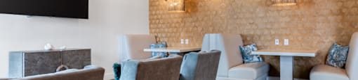 A room with a brown wall and a white table with chairs.