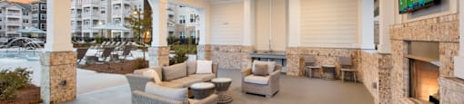 a covered patio with a fireplace and a tv