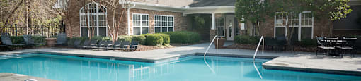 A pool with a 3 feet depth sign in front of a house.