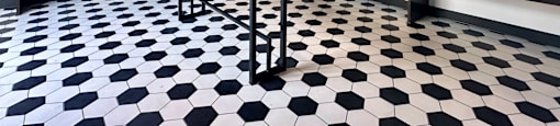 a small table in a room with a black and white checkered floor