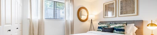 a bedroom with a large bed and a window