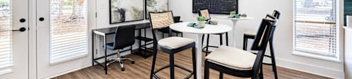 an office with chairs and desks and a chalkboard on the wall