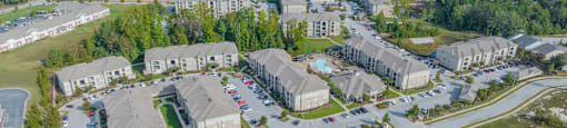 an aerial view of a neighborhood of houses and cars in a parking lot