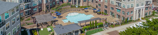 an aerial view of a large apartment complex with a pool