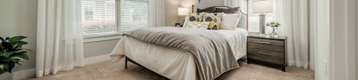 a bedroom with a bed and two windows