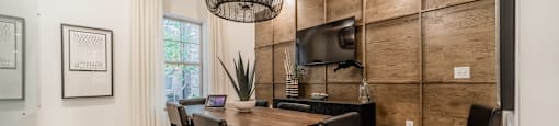 a conference room with a table and chairs and a tv