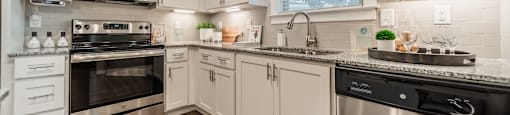 a kitchen with stainless steel appliances and white cabinets