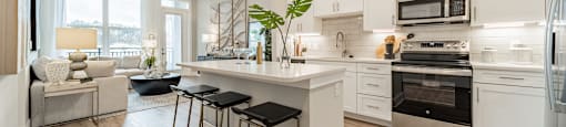 A modern kitchen with white cabinets and a large island.
