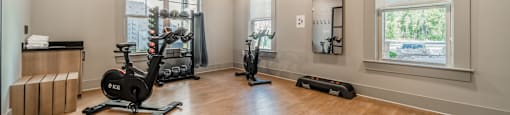 a home gym with exercise equipment and windows