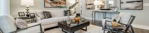 a living room with couches and chairs and a table