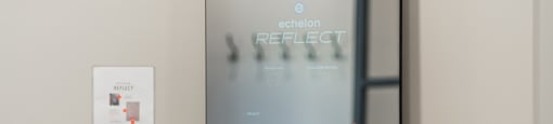 a mirror with a reflection of a bike in front of a door