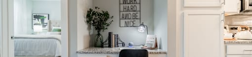 a home office with a desk and a chair and a bedroom
