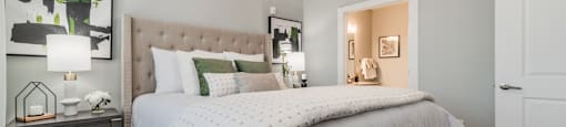a bedroom with a large bed and a ceiling fan