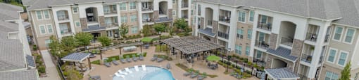 an aerial view of an apartment complex with a large swimming pool