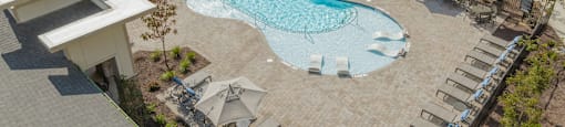 an aerial view of an apartment building with a swimming pool