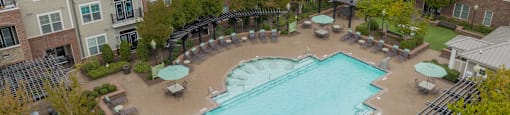 an aerial view of an outdoor swimming pool and resort building