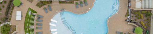 an overhead view of a swimming pool in front of a resort pool