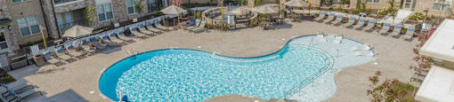 an aerial view of a swimming pool at an apartment building