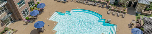 a large swimming pool in front of a building