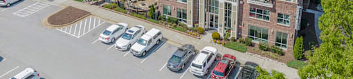 an aerial view of a large apartment complex with a swimming pool and parking lot