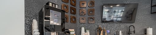 a kitchen with white cabinets and a tv on the wall