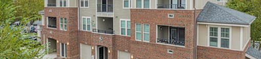 a large brick apartment building with a street in front of it