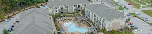 an aerial view of an apartment complex with a swimming pool