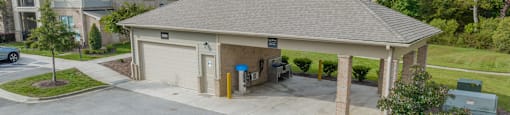 a large parking lot with a garage and a house