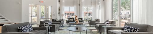 a living room with couches and chairs and a rug
