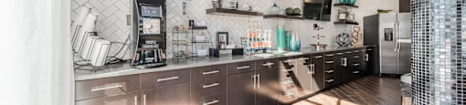 a kitchen with stainless steel appliances and a wood floor