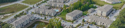 an aerial view of a city with houses and a parking lot
