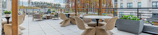 A wooden pergola over a patio with a table and chairs.