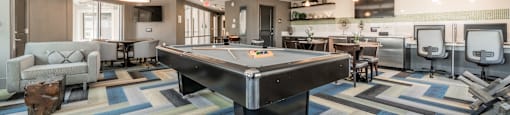 a spacious game room with a pool table and ping pong table