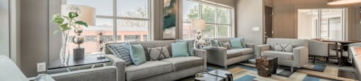 a living room filled with furniture and a large window