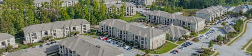 an aerial view of a group of houses in a parking lot