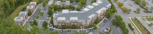 an aerial view of a parking lot and buildings in a city