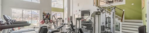 a gym with treadmills and other exercise equipment