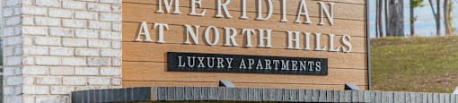 A sign for Meridian at North Hills Luxury Apartments is displayed.
