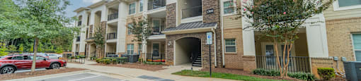 an apartment building with a parking lot and a street