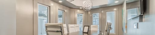a conference room with a long table and chairs and a flat screen tv on the wall