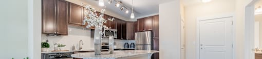 a kitchen with an island and stools