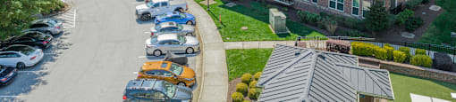 a large apartment building with a parking lot in front of it