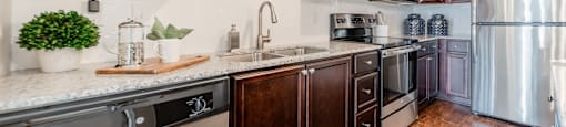 a kitchen with wooden cabinets and stainless steel appliances