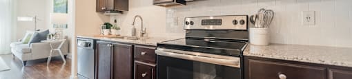 a kitchen with dark wood cabinets and stainless steel appliances