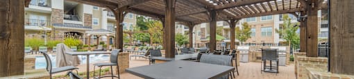 a patio with tables and chairs and a pergola