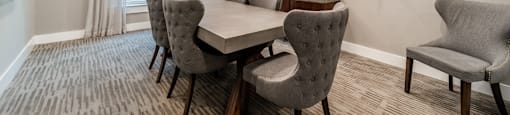 a dining room with a table and chairs and a tv