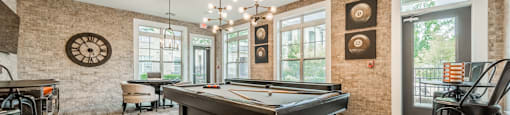 a game room with a pool table and a bar