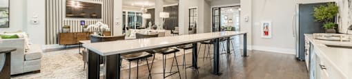 a large kitchen with a long island with bar stools