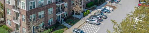 a large apartment building with a parking lot in front of it