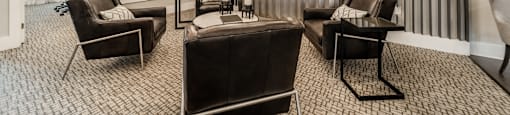 a living room with a couch and chairs
